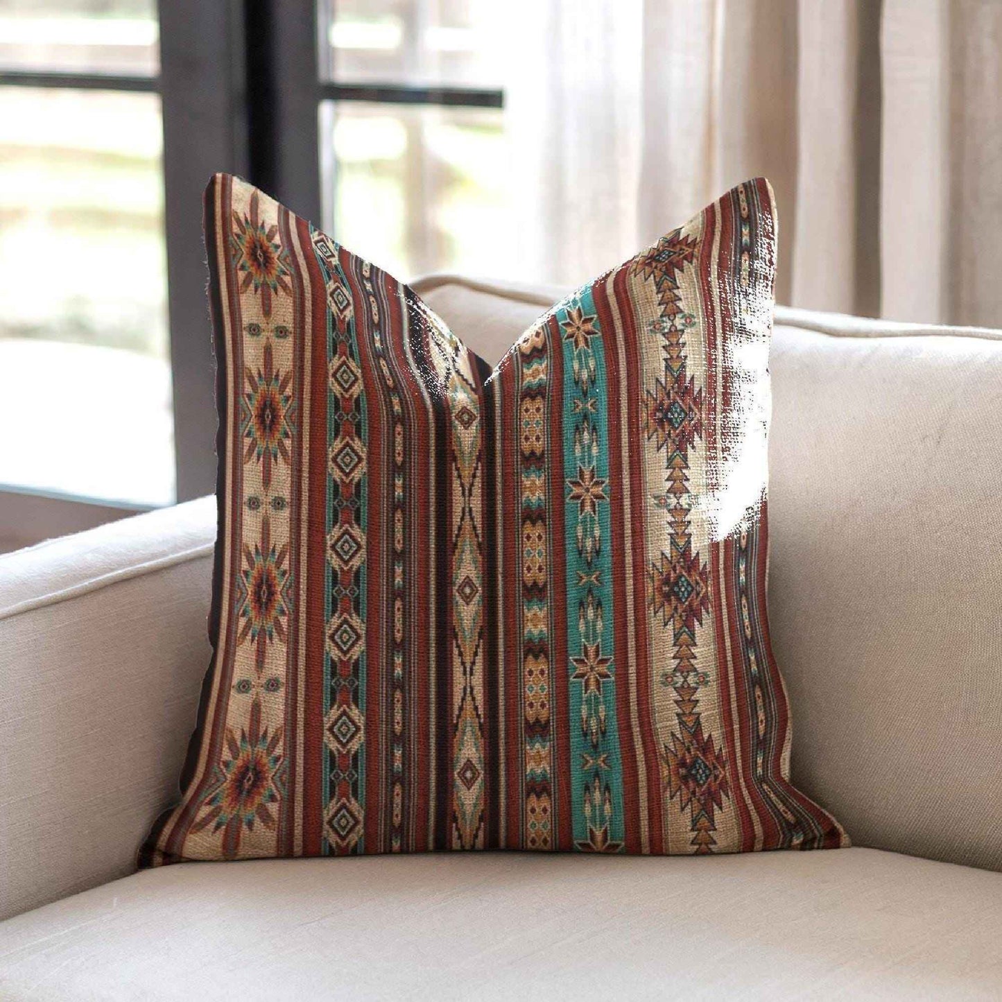 Southwestern throw pillow with geometric pattern styled on a sofa or bed