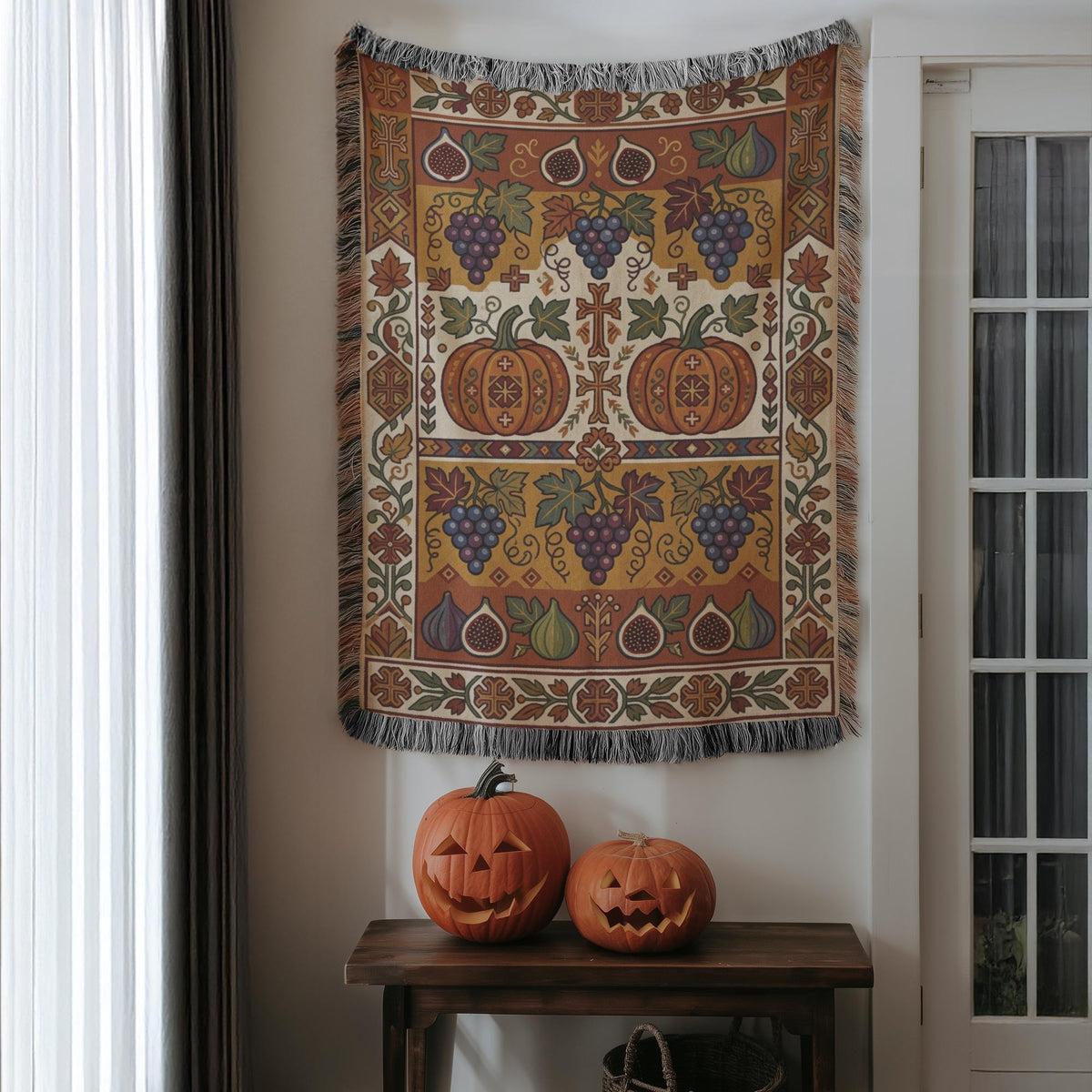 Grape and fig Armenian woven blanket hung on a wall above two carved pumpkins