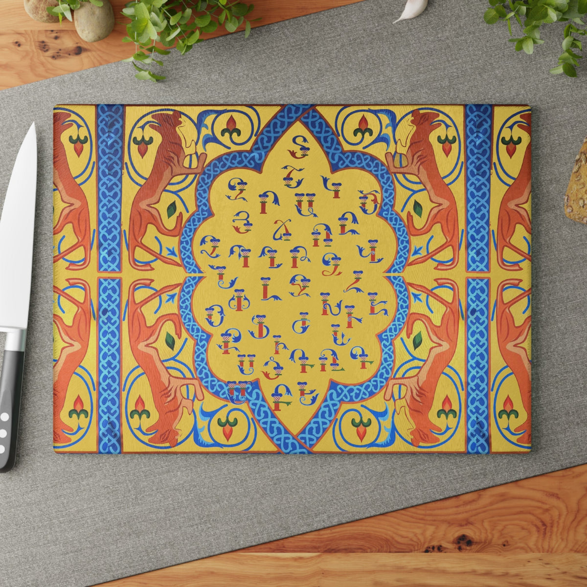 Yellow Armenian alphabet cutting board with orange birds and a blue medallion