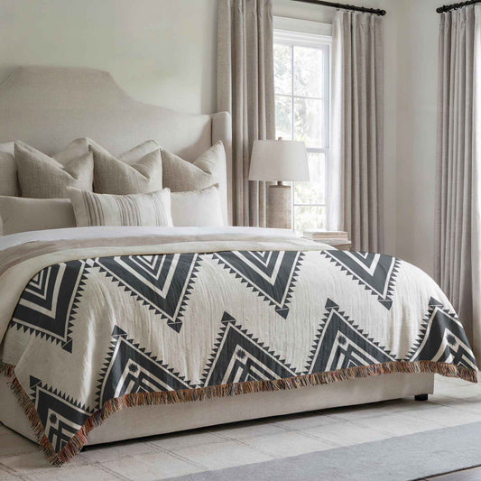 Southwestern woven blanket with geometric pattern styled for layered home decor