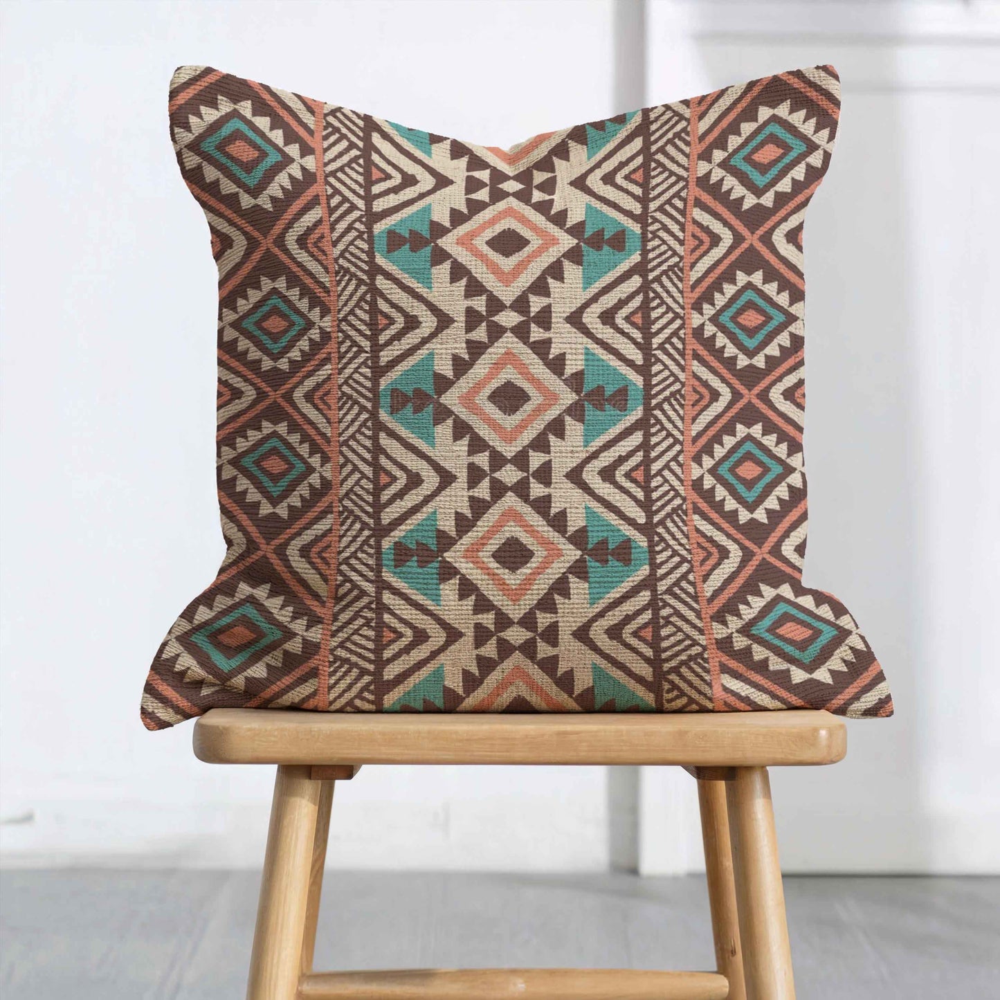 Southwestern pillow cover with geometric pattern styled on a sofa or bed