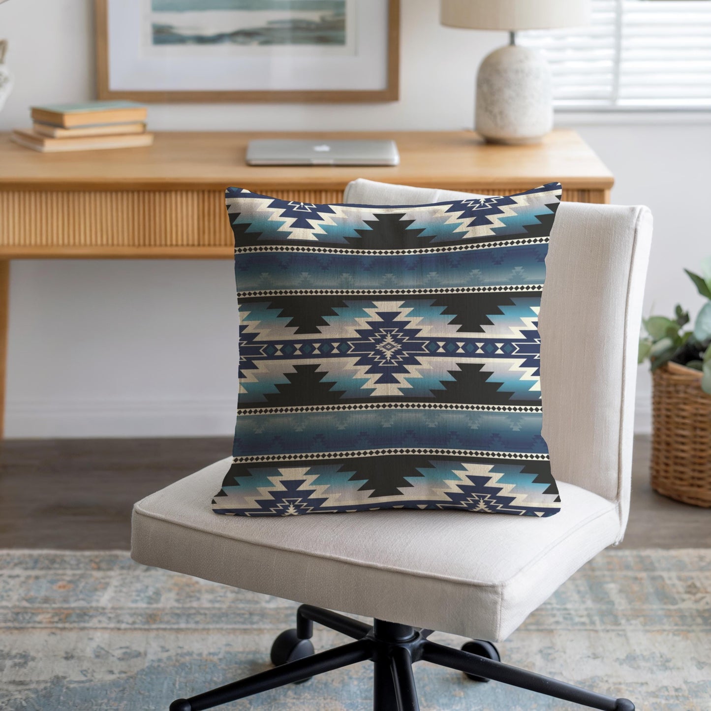 Southwestern throw pillow with geometric pattern styled on a sofa or bed