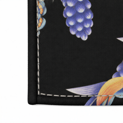 Close view of the blue birds, gold blooms and lavender flowers on black