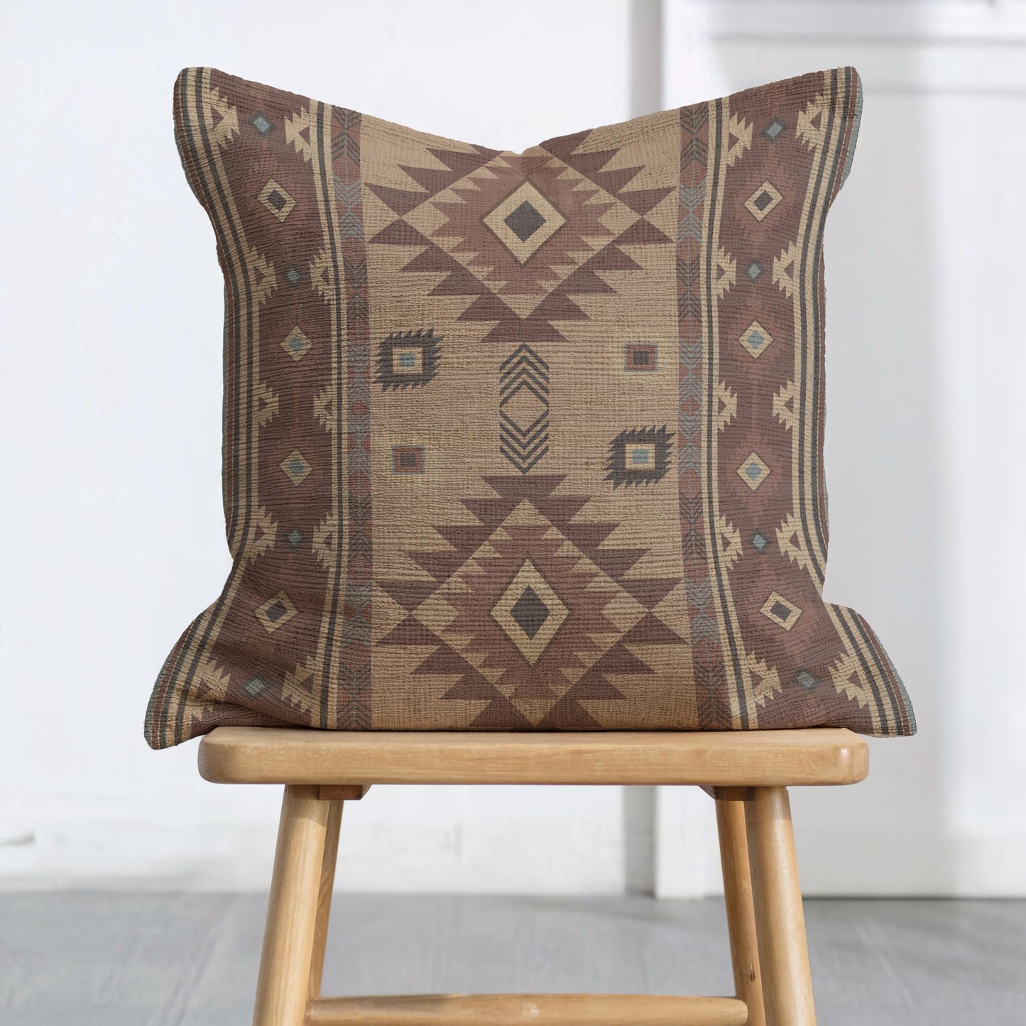 Southwestern throw pillow with geometric pattern styled on a sofa or bed