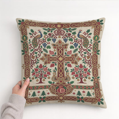 Armenian Christmas pillow held in both hands, showing the woven cross and pomegranate pattern