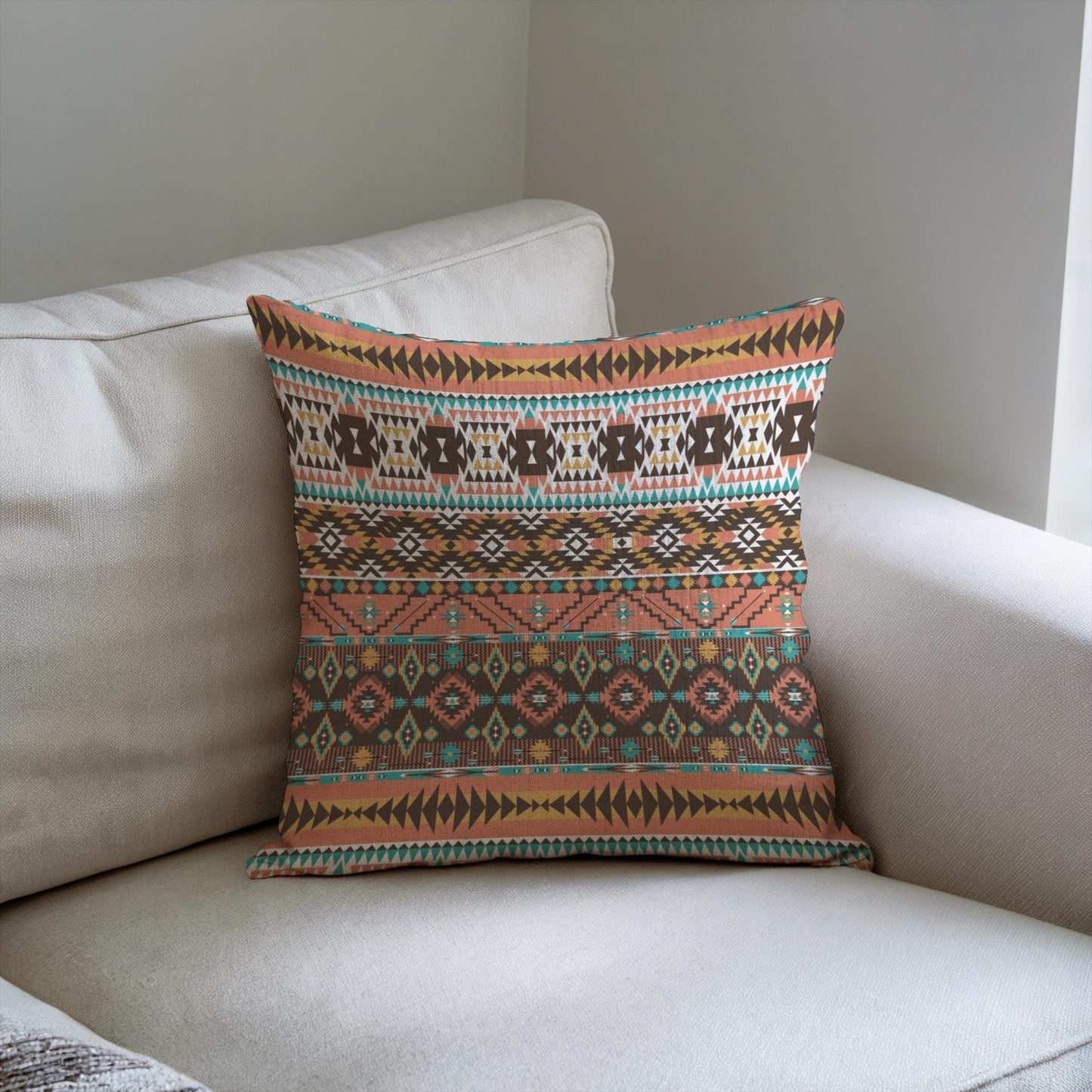 Southwestern throw pillow with geometric pattern styled on a sofa or bed