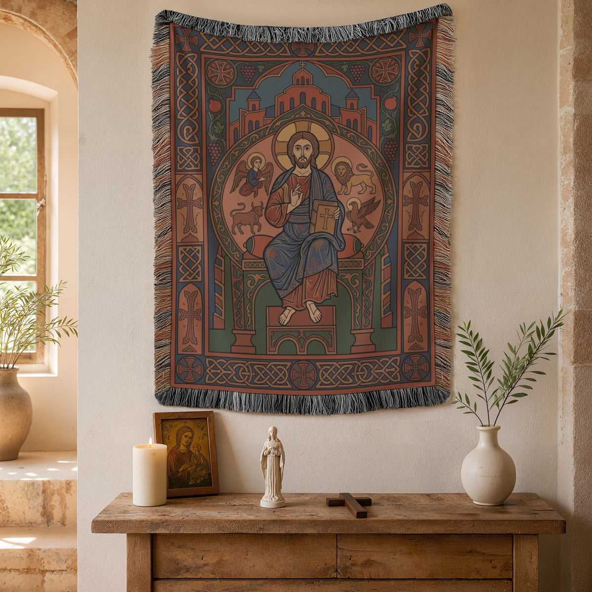 Christ Pantocrator tapestry above a wooden console with a candle and a ceramic vase