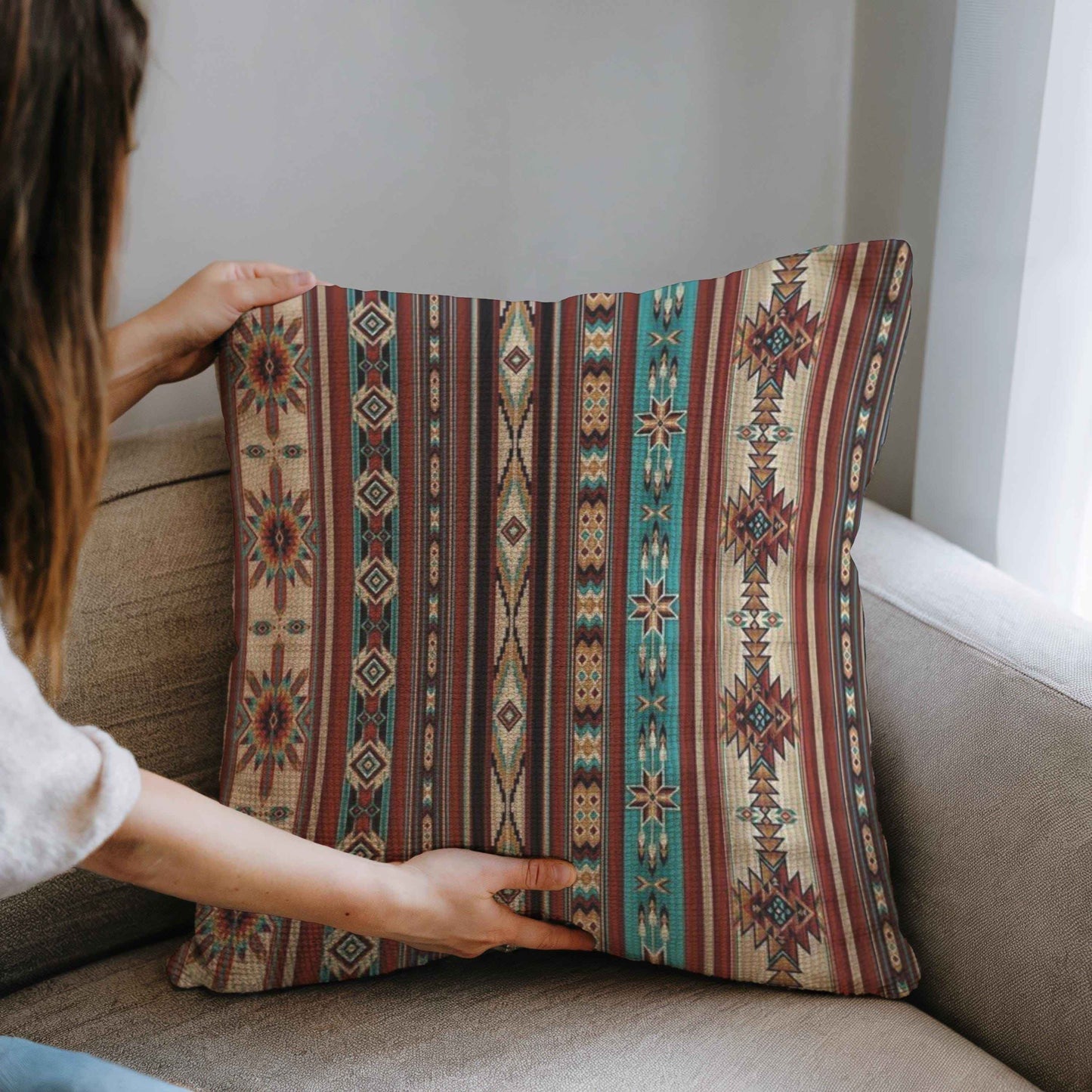 Southwestern throw pillow with geometric pattern styled on a sofa or bed