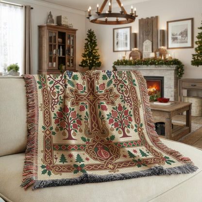 Armenian pomegranate and cross woven blanket draped over a beige sofa near a fireplace with a Christmas tree