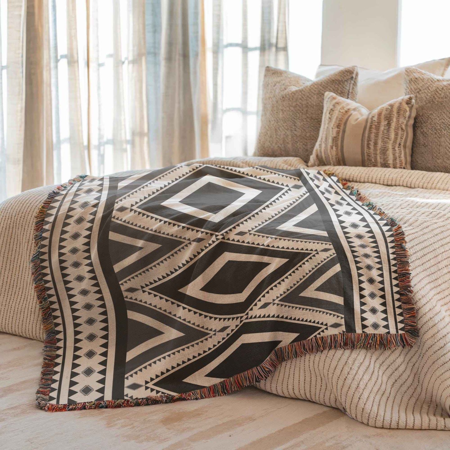 Southwestern woven blanket with geometric pattern styled for layered home decor