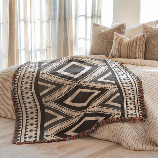 Southwestern woven blanket with geometric pattern styled for layered home decor