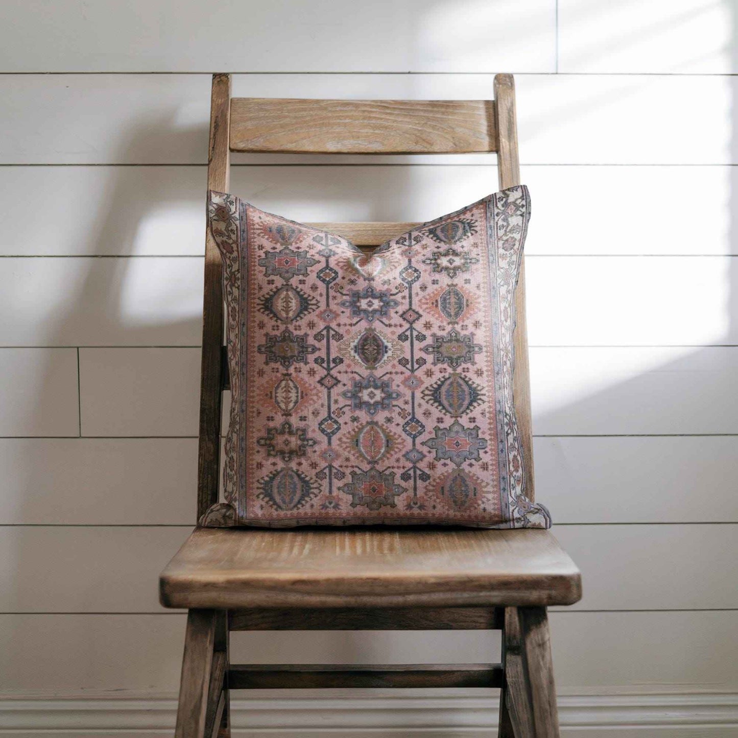 Anatolian Inspired throw pillow with rug-style pattern styled on a sofa or bed