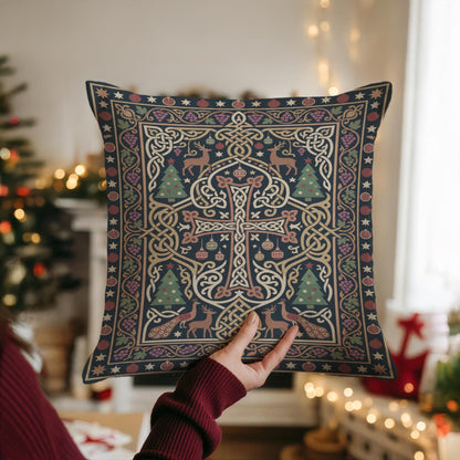 A person is holding up a decorative pillow with an intricate, colorful design featuring a cross, trees, and other festive elements.
