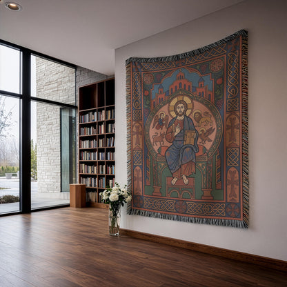 Woven Christ Pantocrator wall hanging in a bright room with a city view and white flowers