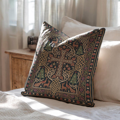 A decorative pillow with a cross and various holiday-themed elements rests on a bed, with a wooden dresser and window in the background.