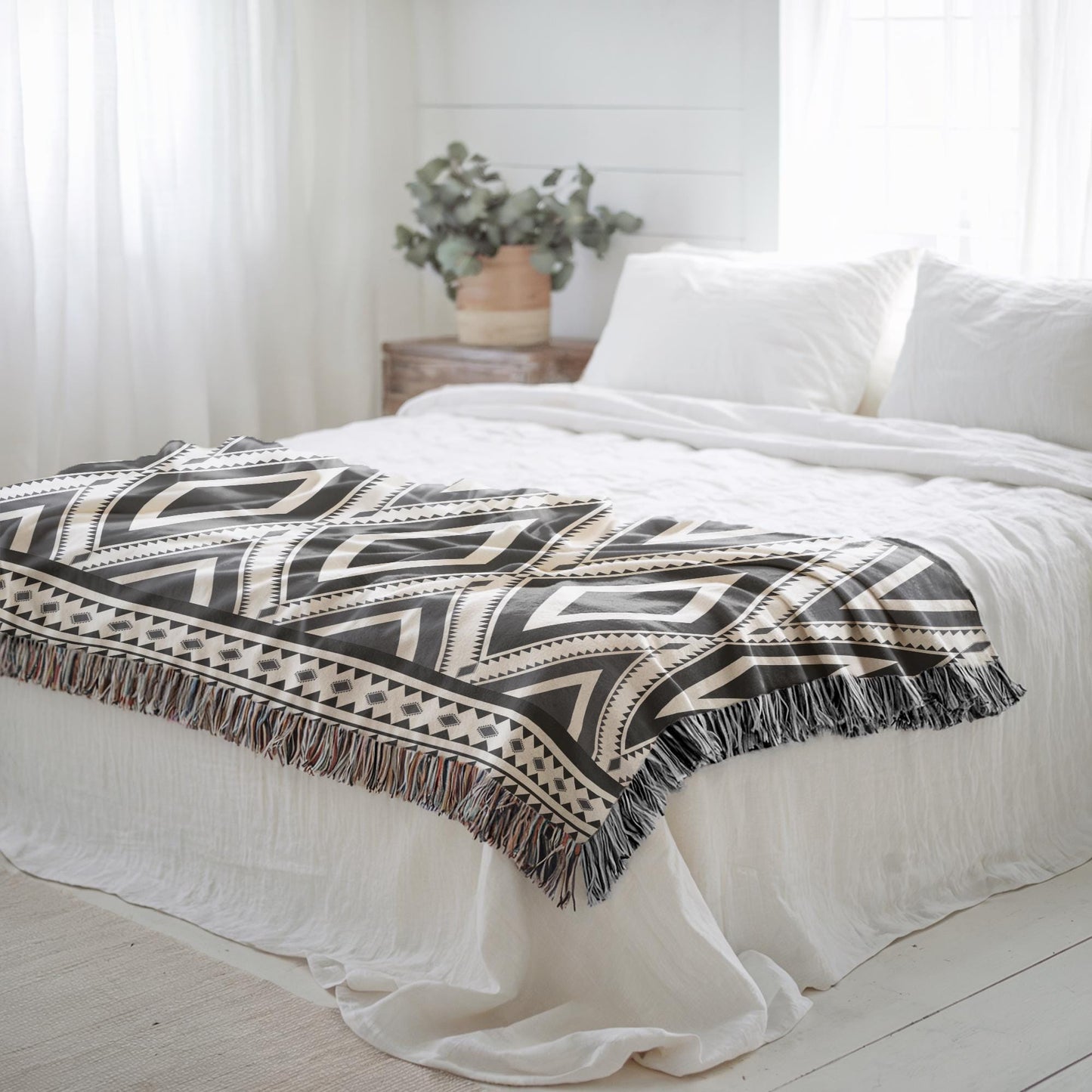 Southwestern woven blanket with geometric pattern styled for layered home decor