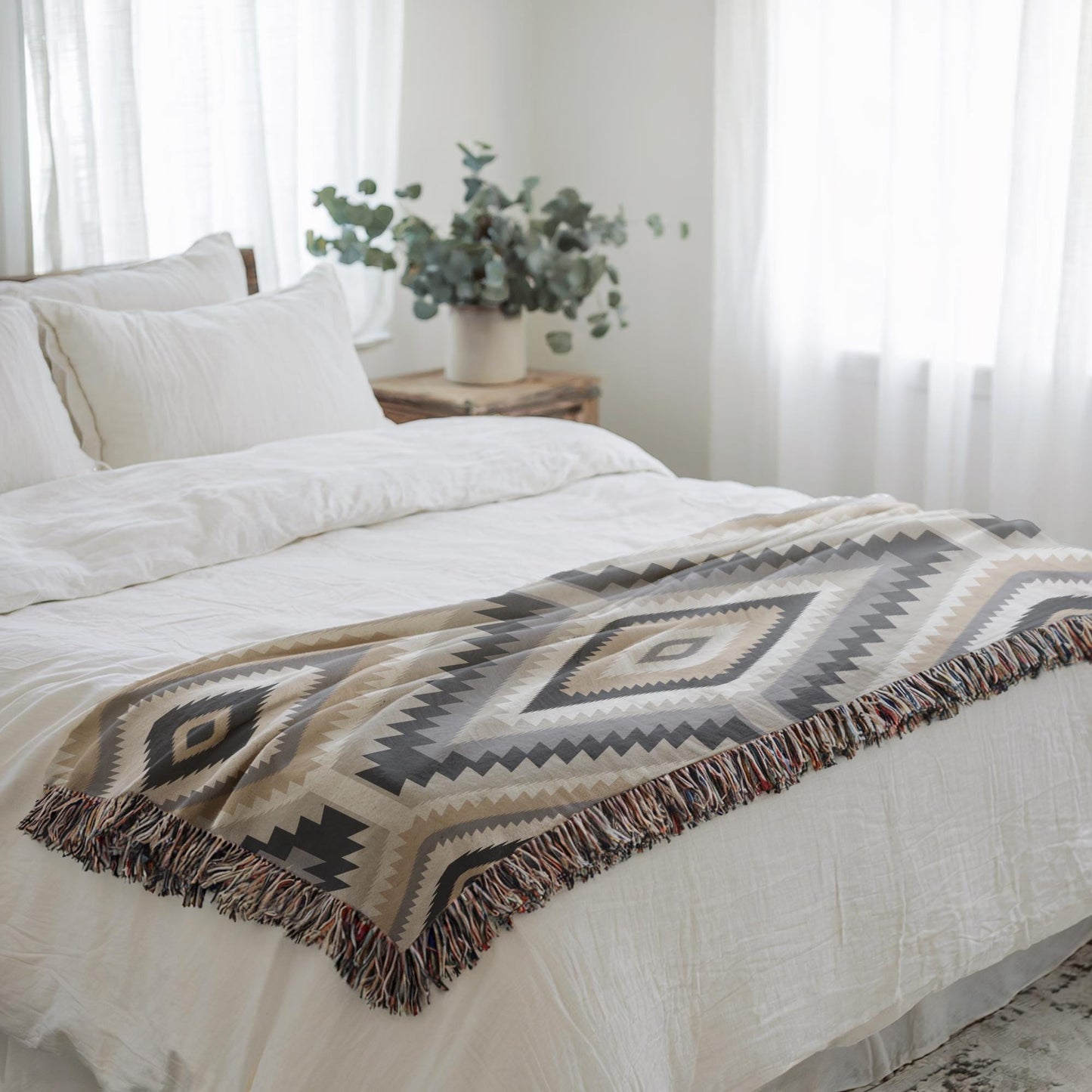 Southwestern woven blanket with geometric pattern styled for layered home decor