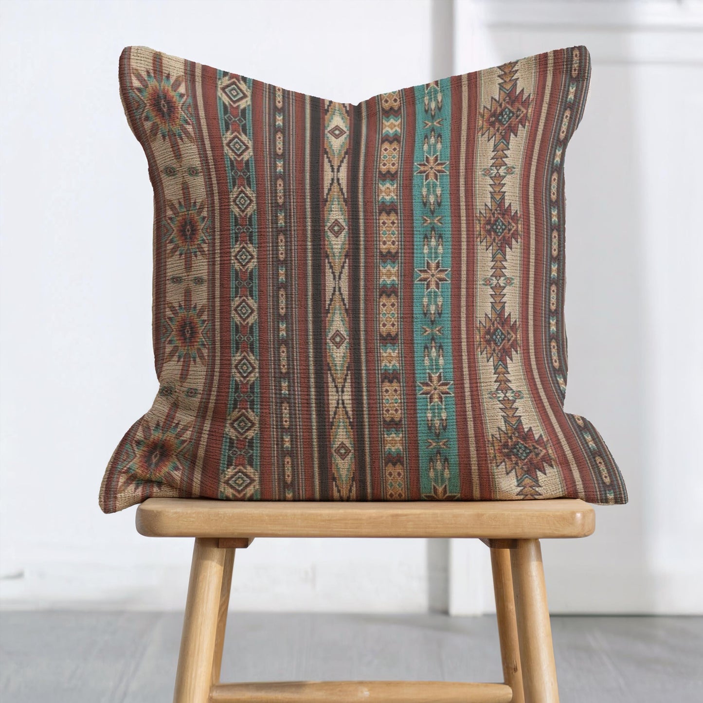 Southwestern throw pillow with geometric pattern styled on a sofa or bed