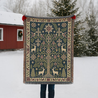 Armenian deer and pomegranate woven blanket held up outdoors in the snow beside a red building with Christmas lights