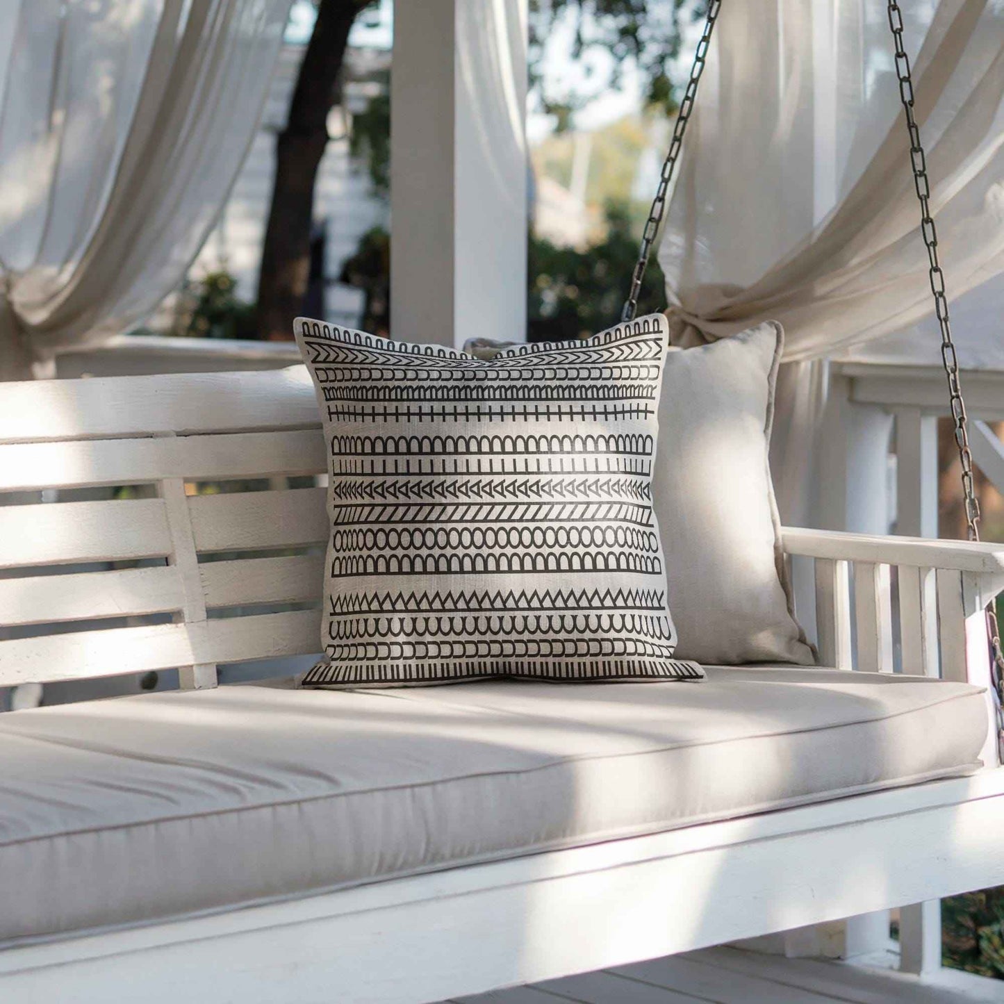Modern Geometric throw pillow with geometric pattern styled on a sofa or bed