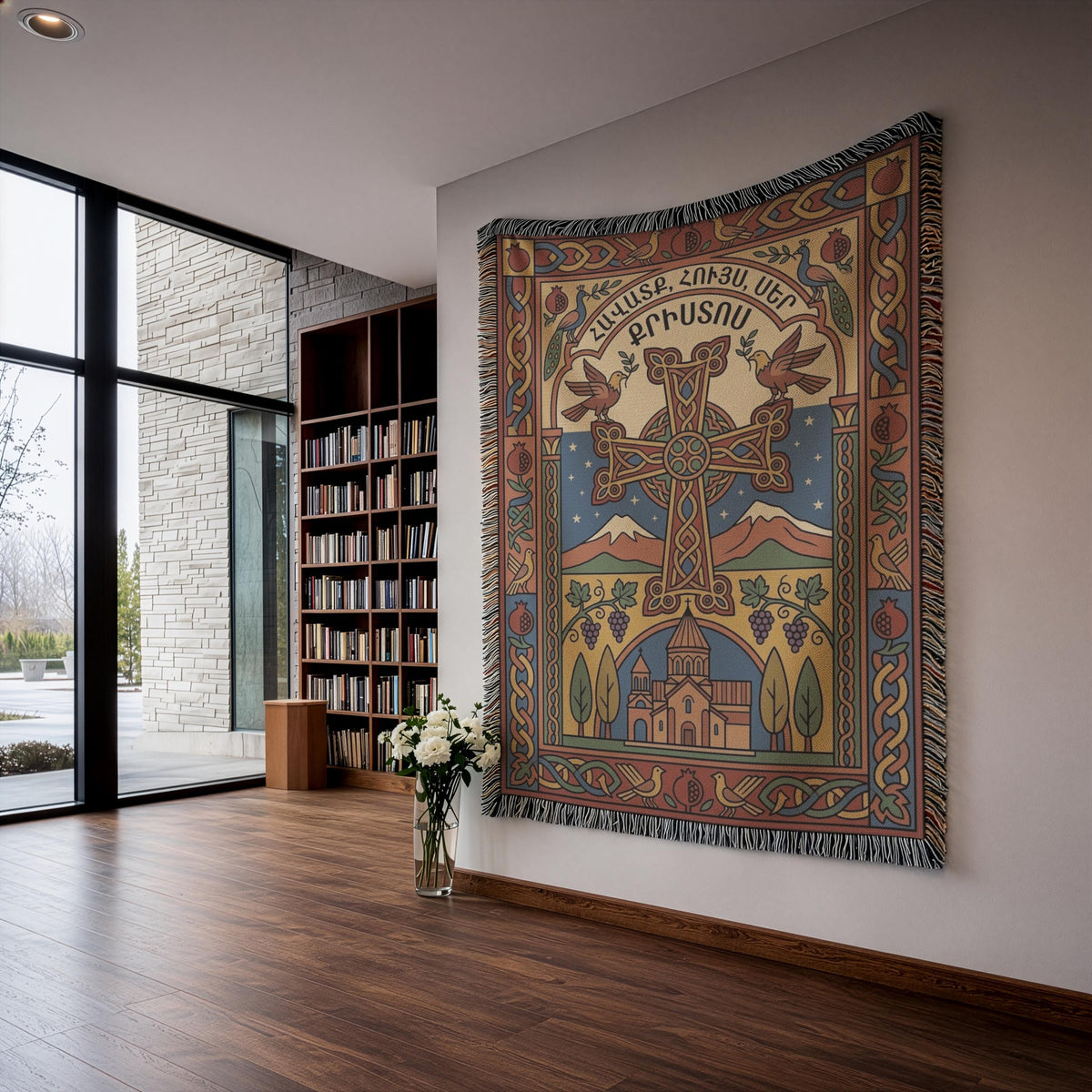 Woven Armenian cross tapestry with Mount Ararat and a church, hung by a window with white flowers below