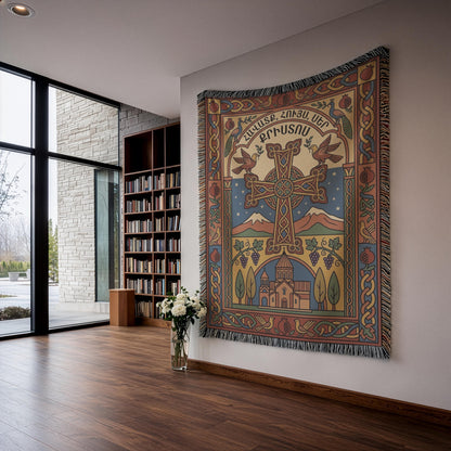 Woven Armenian cross tapestry with Mount Ararat and a church, hung by a window with white flowers below