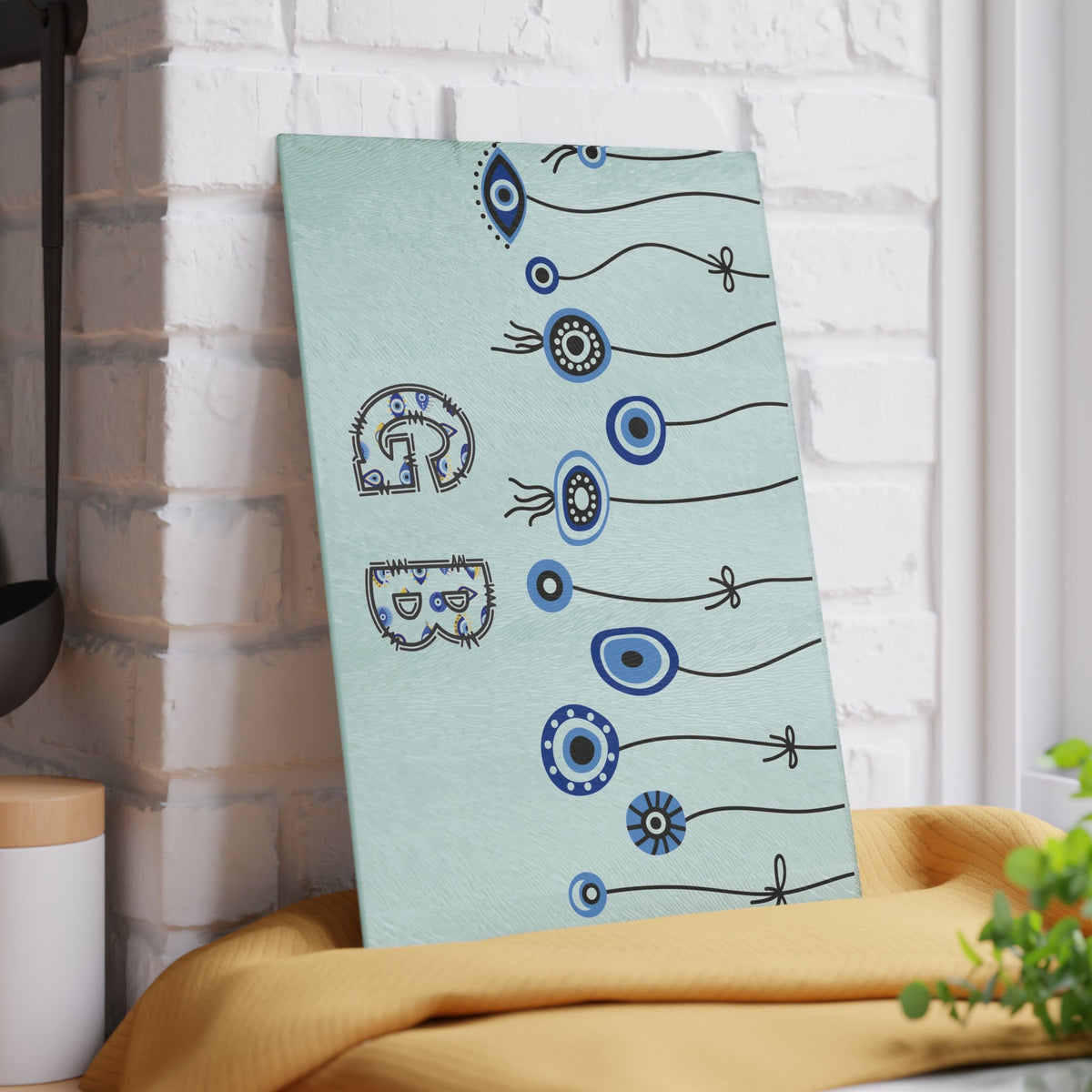 Mint evil eye cutting board with hanging beads close view showing the pattern