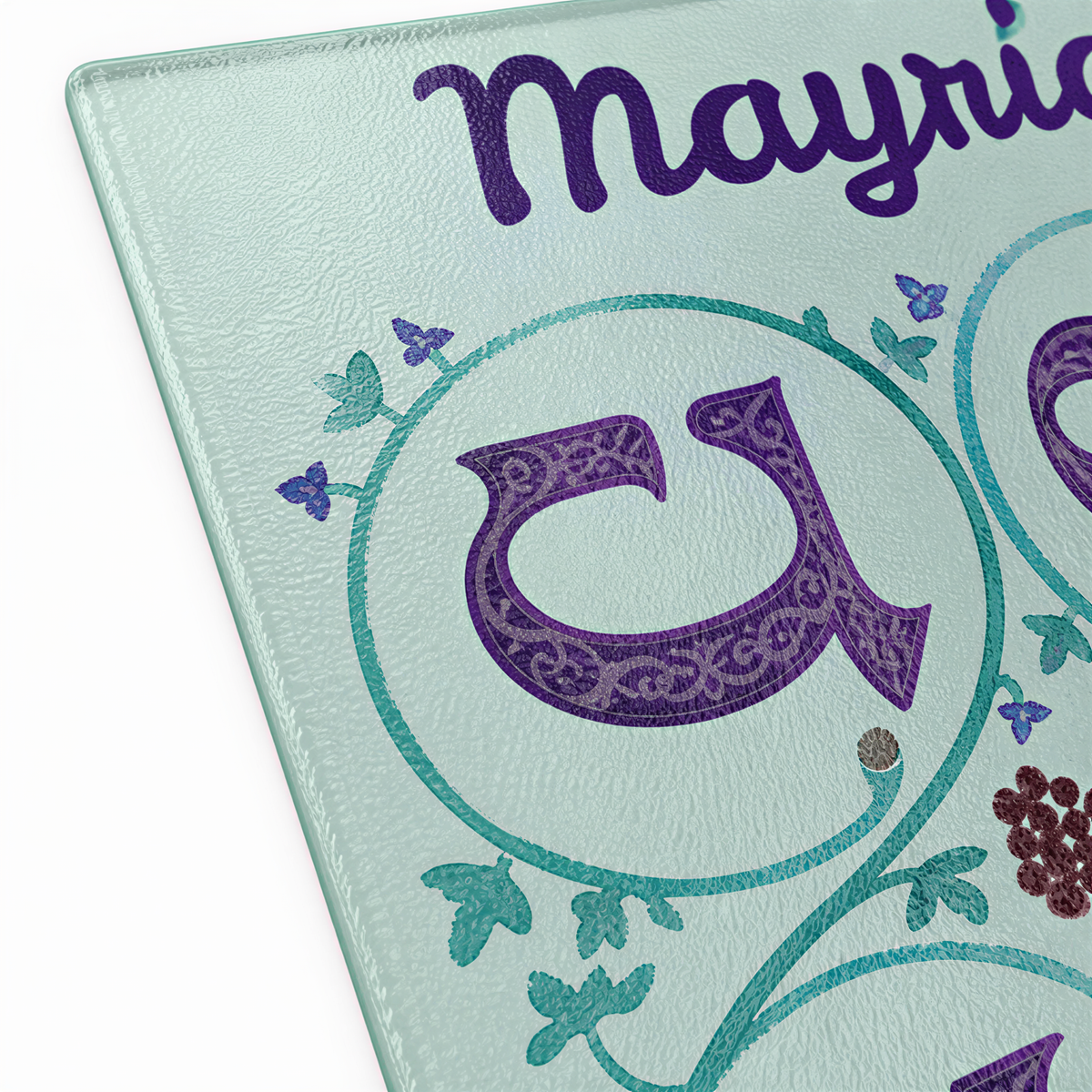 Close view of the name Mayrig in script above a purple Armenian letter in a circle of leaves