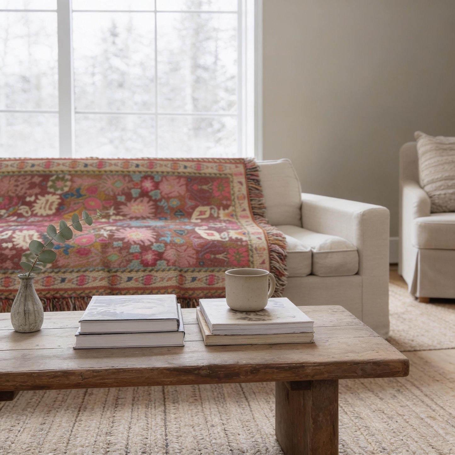 Boho woven blanket with rug-style pattern styled for layered home decor