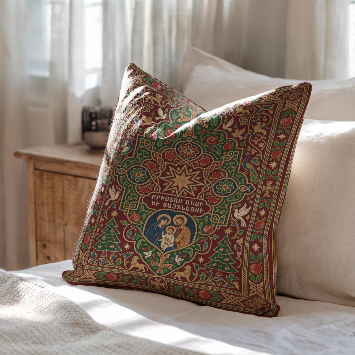 A decorative pillow with an ornate, colorful design sits on a bed, with a wooden dresser and a window in the background.