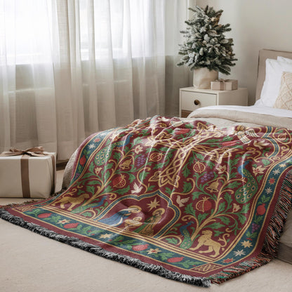 a cozy bedroom scene with a large, colorful, and intricately patterned blanket on a bed, a small Christmas tree, and a gift box on the floor.