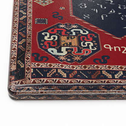 Close view of the navy octagon of Armenian letters inside the red carpet border