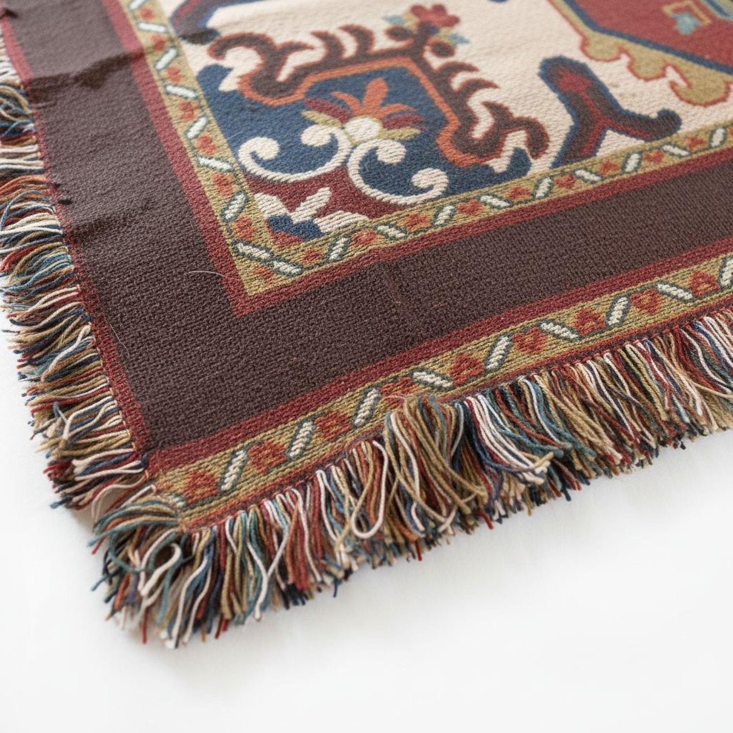 Anatolian Inspired woven blanket with rug-style pattern styled for layered home decor