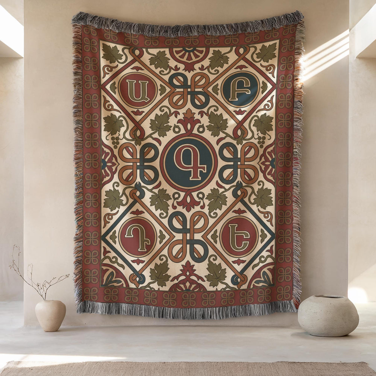 Armenian letter wall tapestry hung above pale ceramic vases on a cream wall