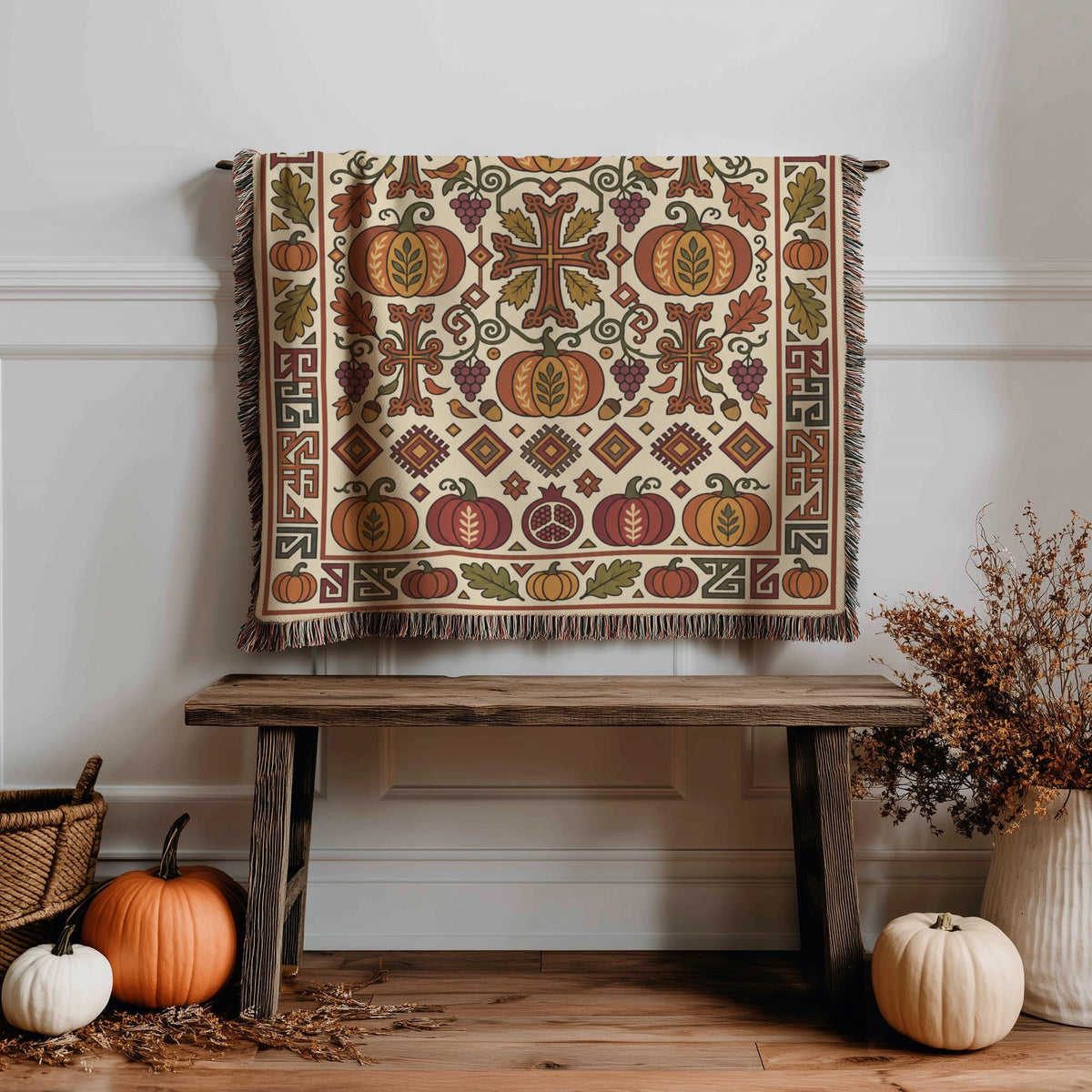 Armenian Ghapama blanket in cream and rust draped over a wooden bench beside pumpkins and dried flowers