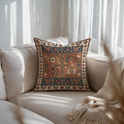 Woven pumpkin pillow centred on a pale sofa with sheer curtains behind