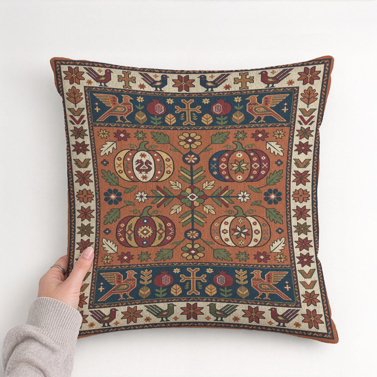 Full front view of the woven pumpkin pillow, showing the complete harvest pattern