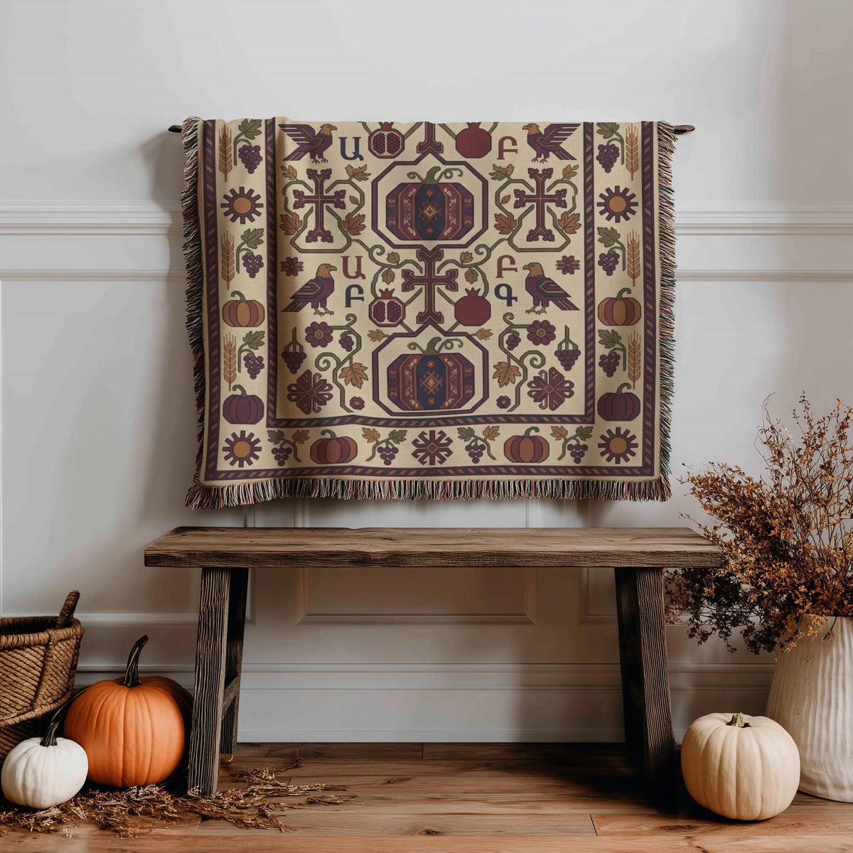 Fringed burgundy and cream Armenian throw hanging against a pale wall