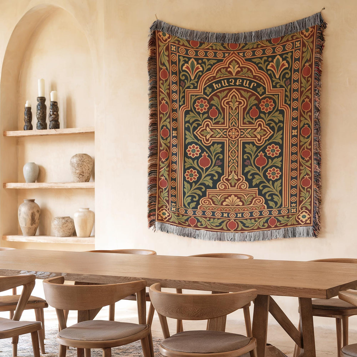 Khachkar cross tapestry in a pointed arch in a plaster niche beside shelves of candles and ceramics