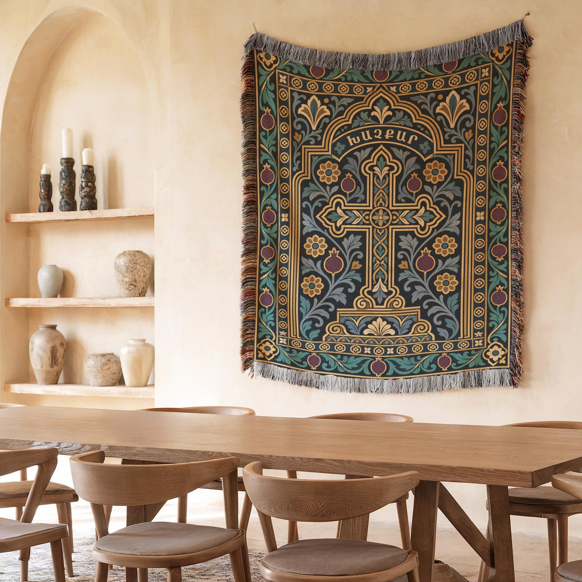 Teal khachkar cross tapestry in a pointed arch in a plaster niche beside shelves of candles and ceramics