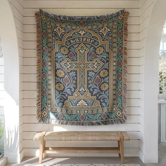 Teal khachkar cross tapestry in a pointed arch hung on white shiplap above a wooden bench